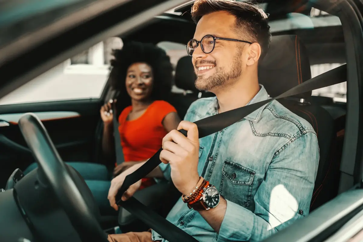 Happy customers in a clean car after Waves Car Wash